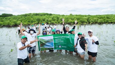 The group photo of the staff of HEINEKEN Cambodia after planting the mangrove trees at the Trapaeng Sangkae community