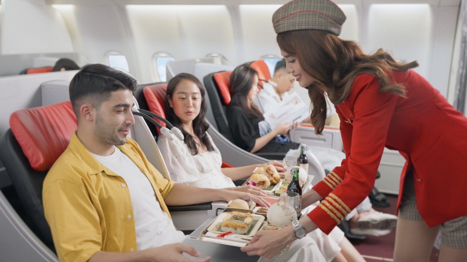 Vietjet flight attendant serving passenger onboard